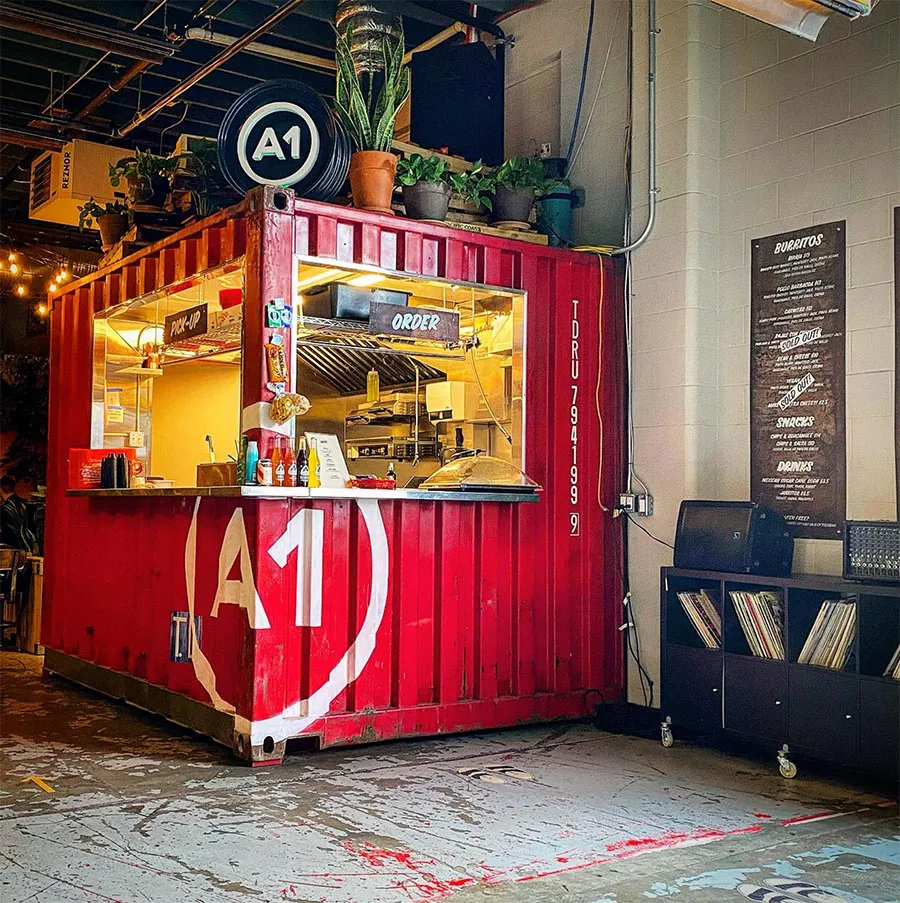 A red shipping-container food kiosk built by Brothers Fabrication
